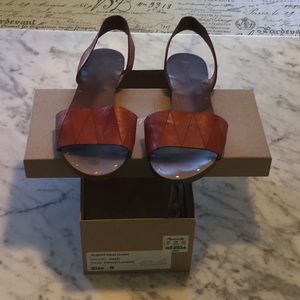 Orange colored sandals by Madewell